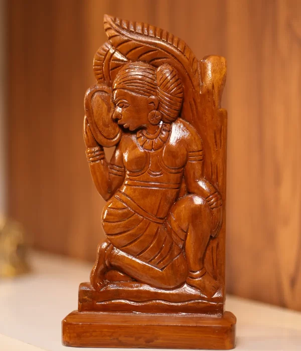 home decor of wooden artwork featuring a female figure and a mirror