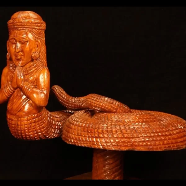 wooden artwork depicting a serpent women