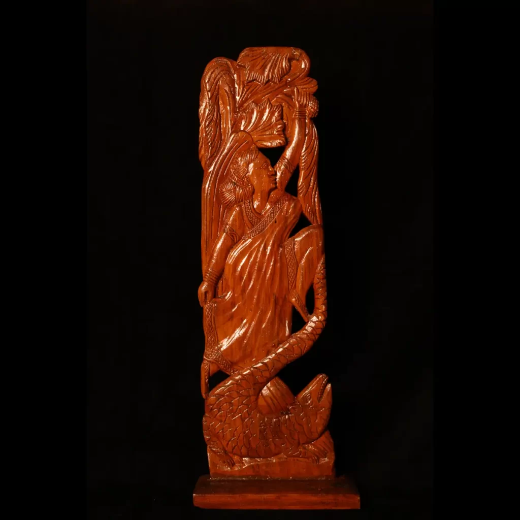 wooden artwork featuring a woman and a snake