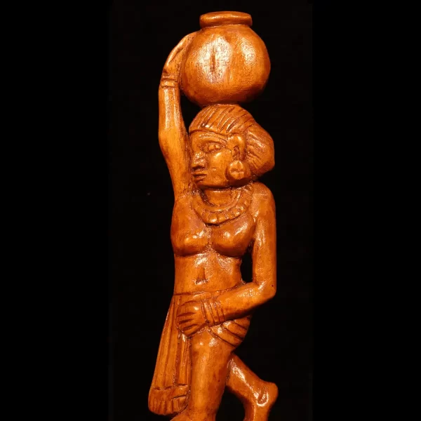 wooden artwork of a woman with a pot